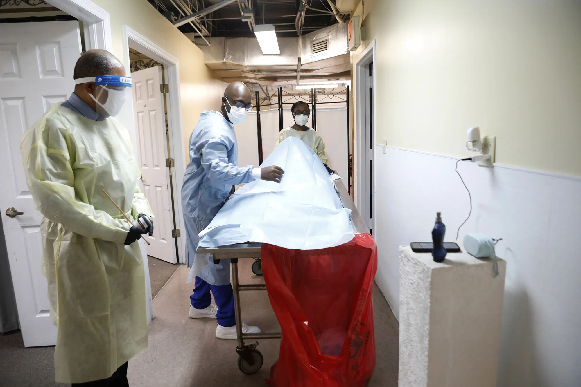 A funeral home director and mortician assistants prepare a funeral service for a man who died of Covid-19 in Tampa, Florida.