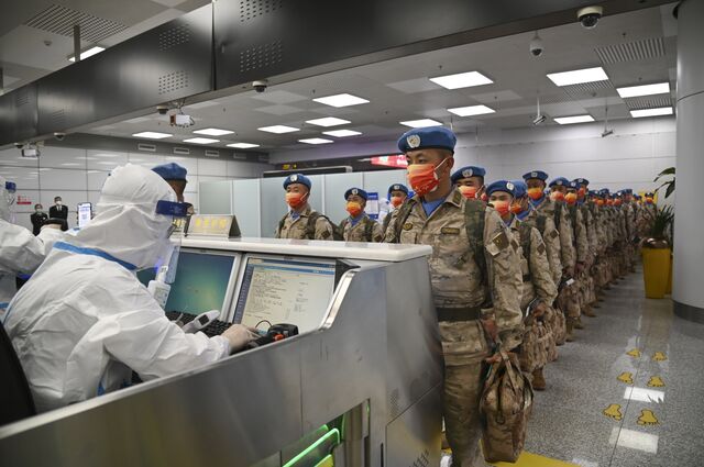 A Chinese peacekeeping to be stationed in Juba, South Sudan, part of a United Nations peacekeeping mission, pass the border inspection at an airport in Zhengzhou in central China's Henan province Tuesday, Dec. 06, 2022.