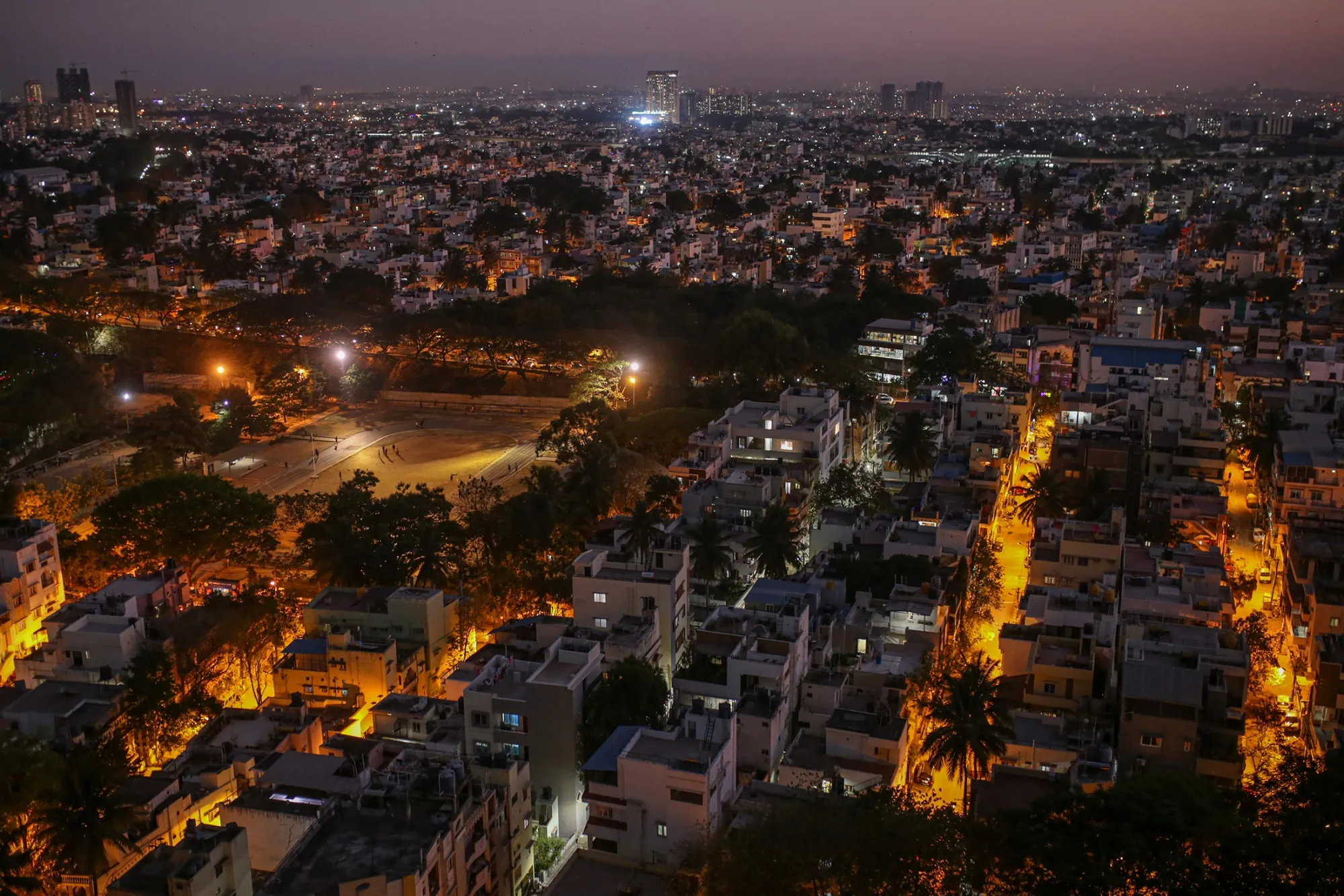 Commercial and residential buildings at dusk in India.