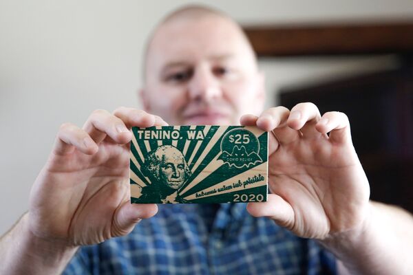 Mayor Wayne Fournier of Tenino, Washington, displays $25 in wooden money. The city recently revived a Depression-era economic recovery tactic: printing its own local currency on planks of wood. 