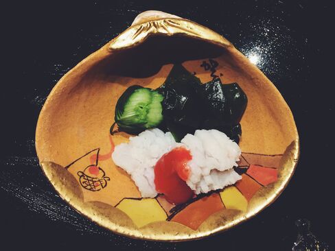After the tempura, you'll get a couple of bites of poached pike with sour plum sauce, slippery seaweed, and cucumber, served in a painted clam shell.