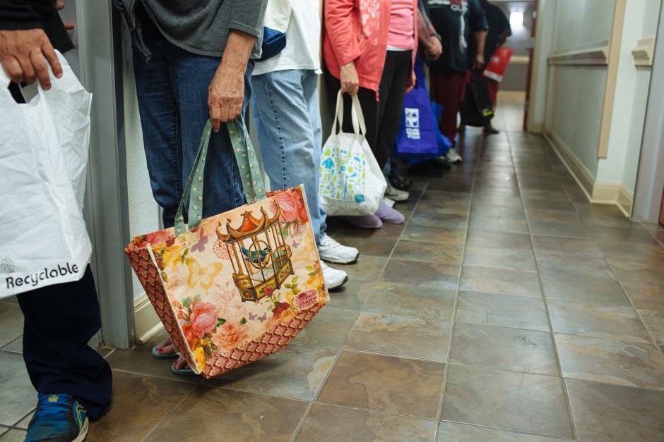 People hold empty bags in line for a food pantry in Austin, Texas.