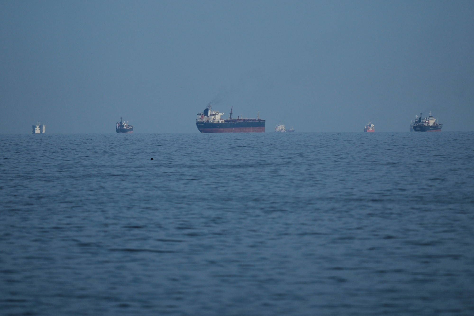 Oil tankers and cargo ships line up in the Strait of Hormuz on March 11. Photographer: Altaf Qadri/AP Photo