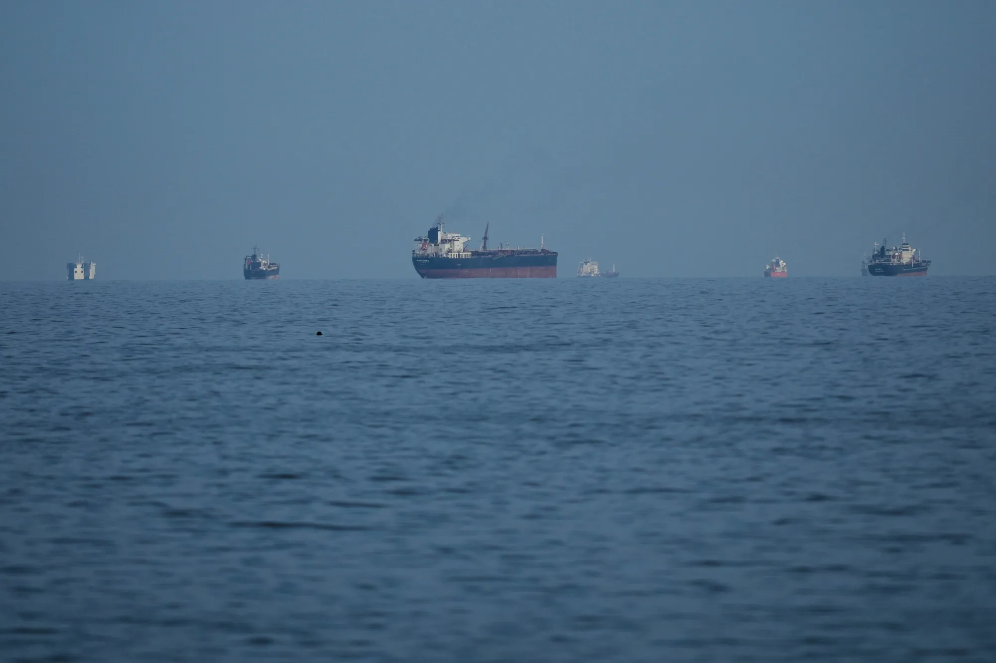 Oil tankers and cargo ships line up in the Strait of Hormuz.