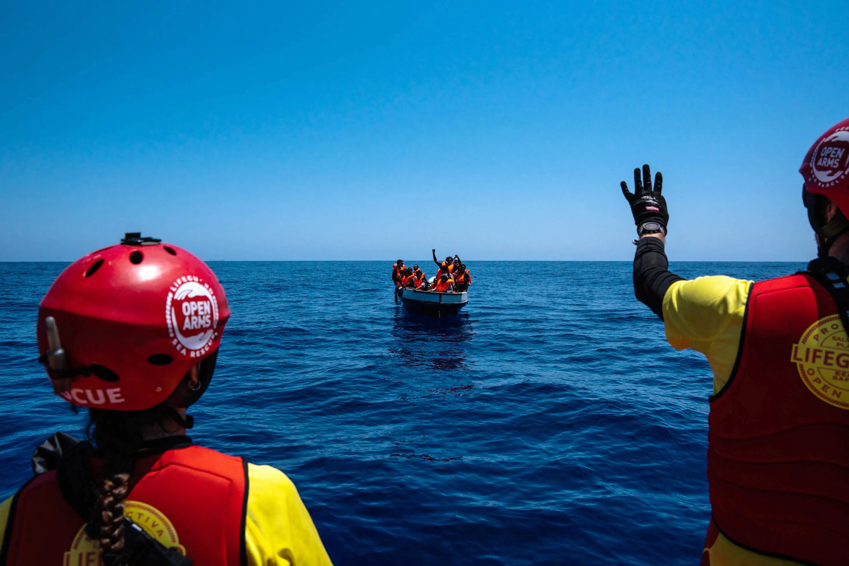 Rescuers approach a migrant boat in the Mediterranean Sea &nbsp;in August.