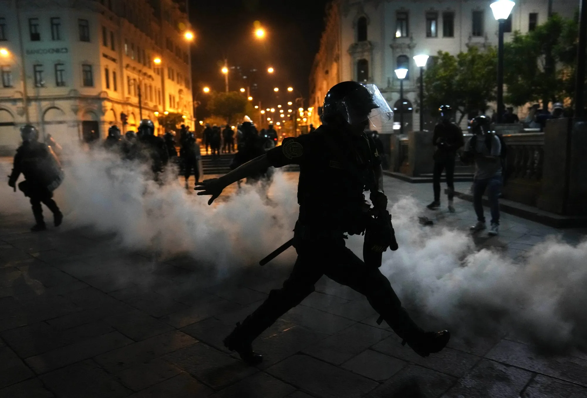Tear gas is thrown back at police trying to break up supporters of ousted President Pedro Castillo at plaza San Martin in Lima on Dec. 11. (AP Photo/Martin Mejia)