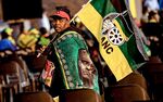 An ANC supporter walks with the party's flag in Johannesburg, South Africa on Nov 13.