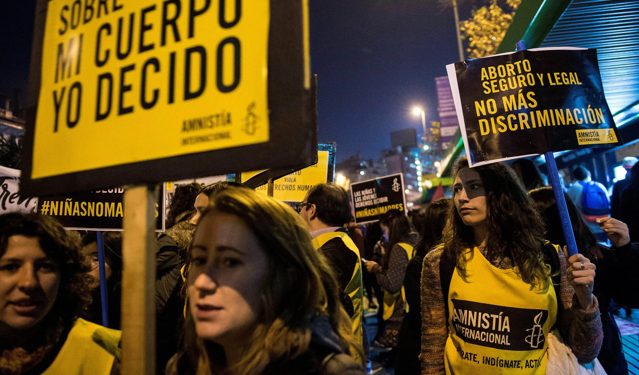 Activists holding placards supporting abortion rights take part in a demonstration in Santiago, on July 25, 2017.
