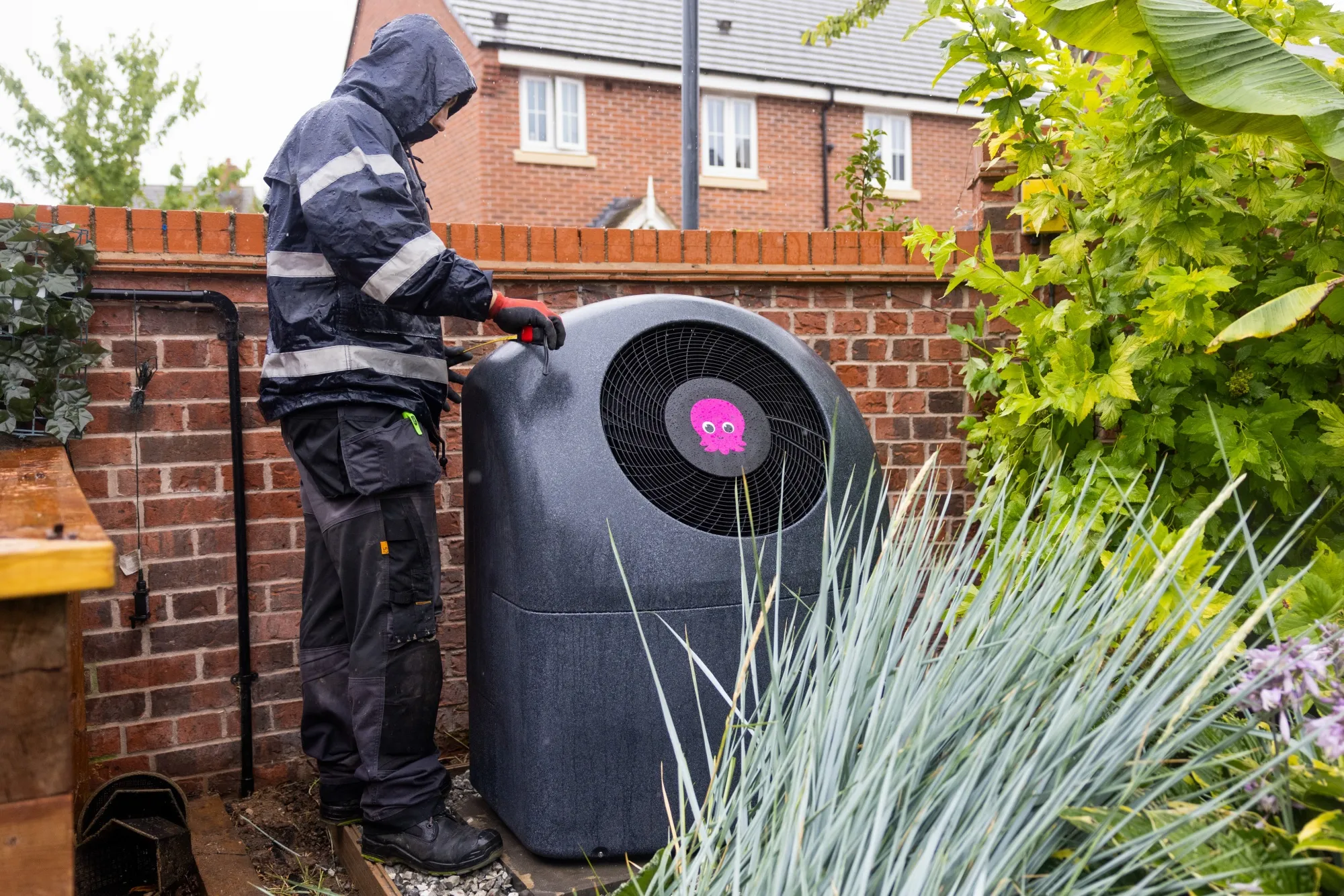 An engineer installs an Octopus Energy Ltd. Cosy 6 heat pump at a residential property in Derby, UK, on&nbsp;July 15.