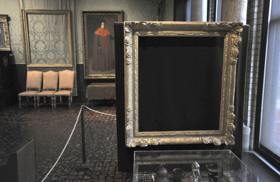 In this file photo, empty frames from which thieves took &quot;Storm on the Sea of Galilee,&quot; left background, by Rembrandt and &quot;The Concert,&quot; right foreground, by Vermeer, remain on display at the Isabella Stewart Gardner Museum in Boston.