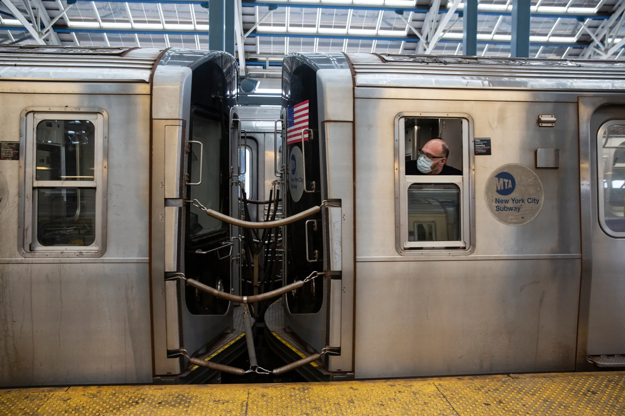 A Metropolitan Transit Authority worker looks out the window of the subway in New York.