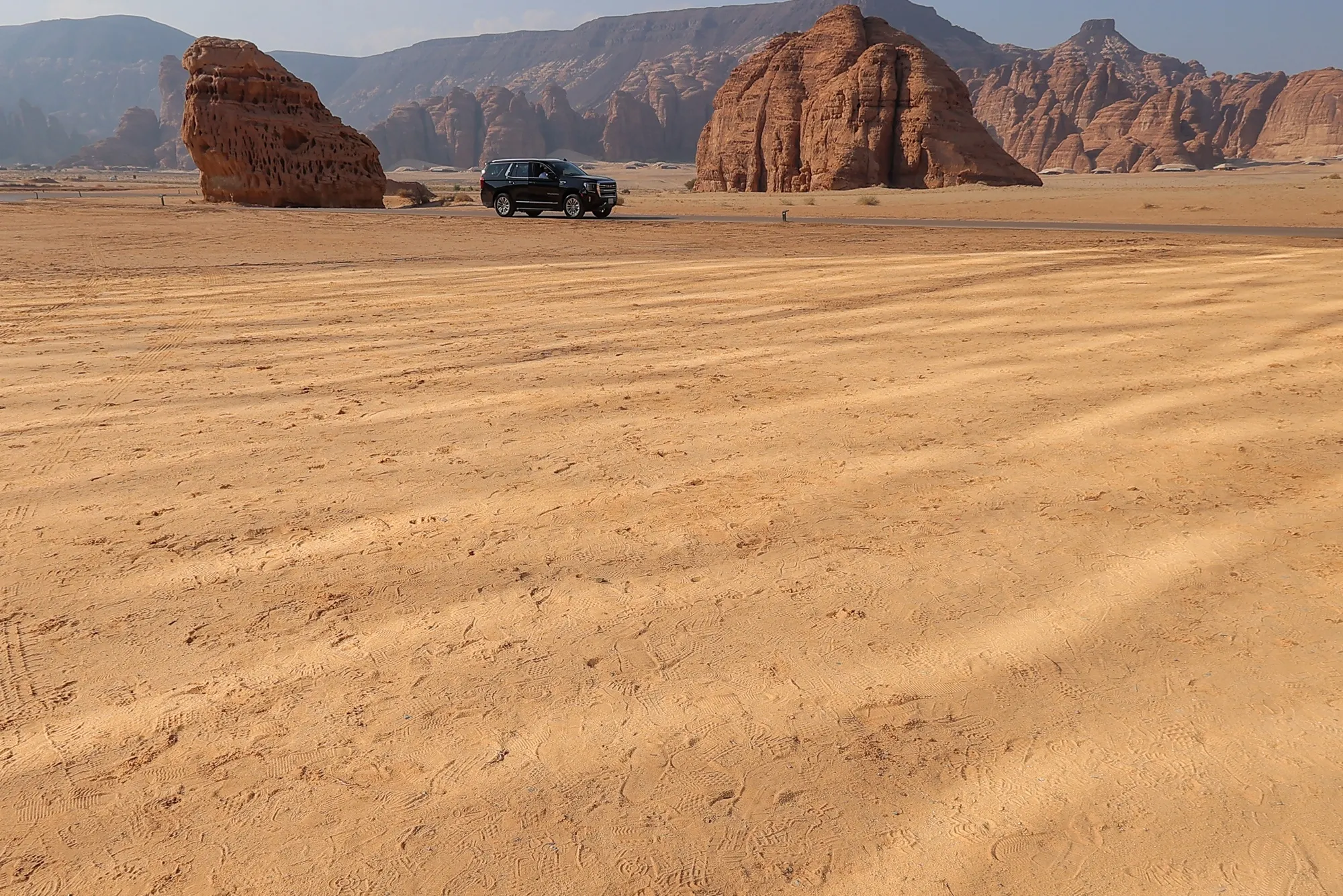 A vehicle travels along a desert road in Al Ula, Saudi Arabia, on Tuesday, Dec. 6, 2022.&nbsp;