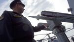 A Russian Navy captain stands in front of an anti-aircraft system on a Russian missile cruiser as it patrols in the Mediterranean Sea, on Dec. 17.
