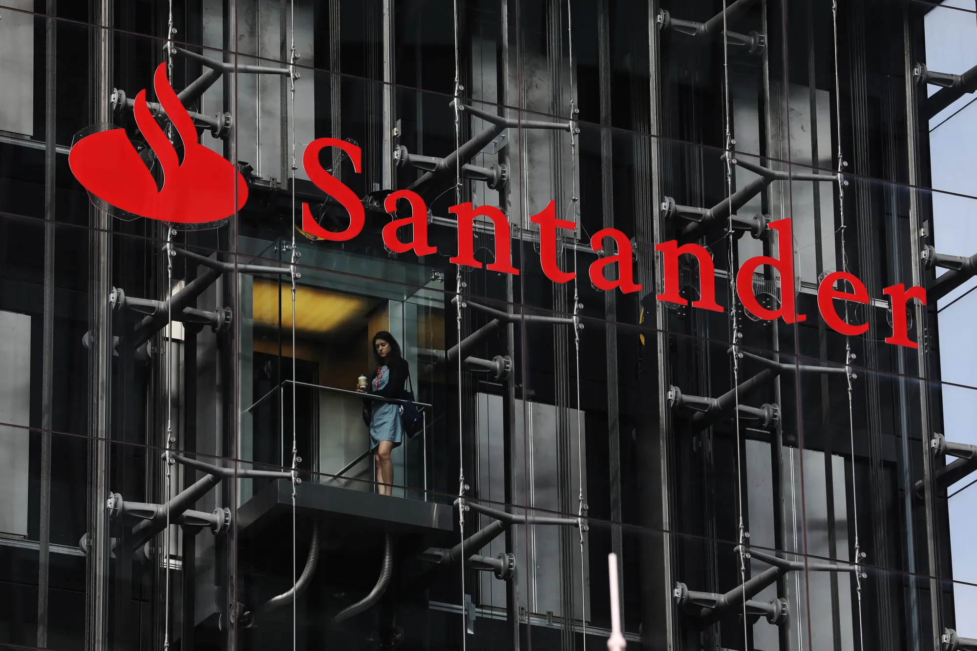 An employee travels in a lift at the offices of Banco Santander SA in London, U.K.