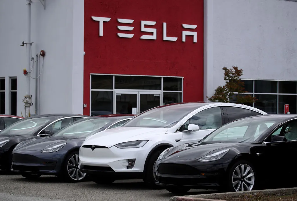 Tesla cars parked in front of a showroom and service center in Burlingame, California.