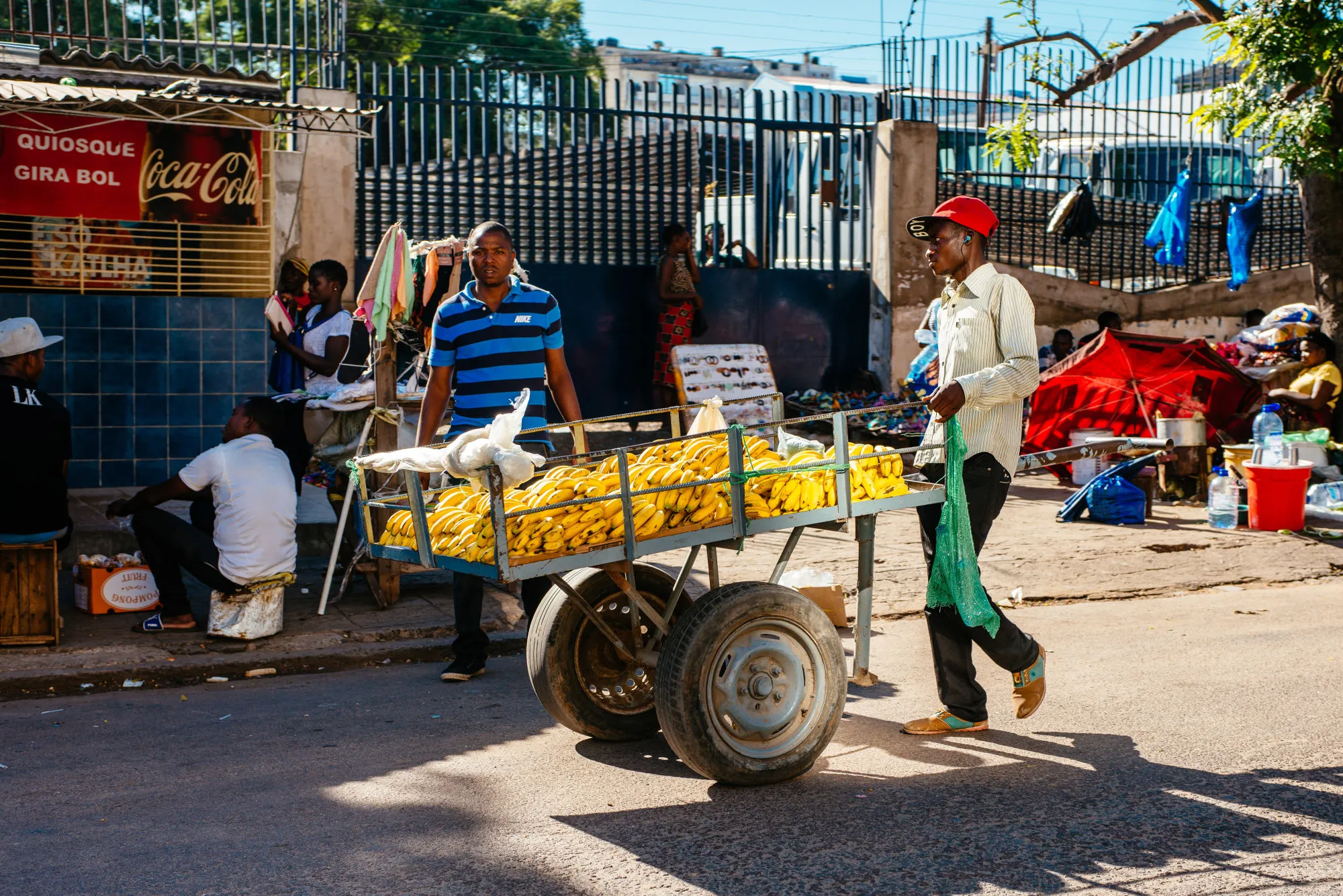 A street trader wheels a cart laden with bananas along a street in Maputo, Mozambique.
