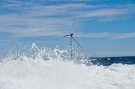Wind turbines stand at an offshore wind farm