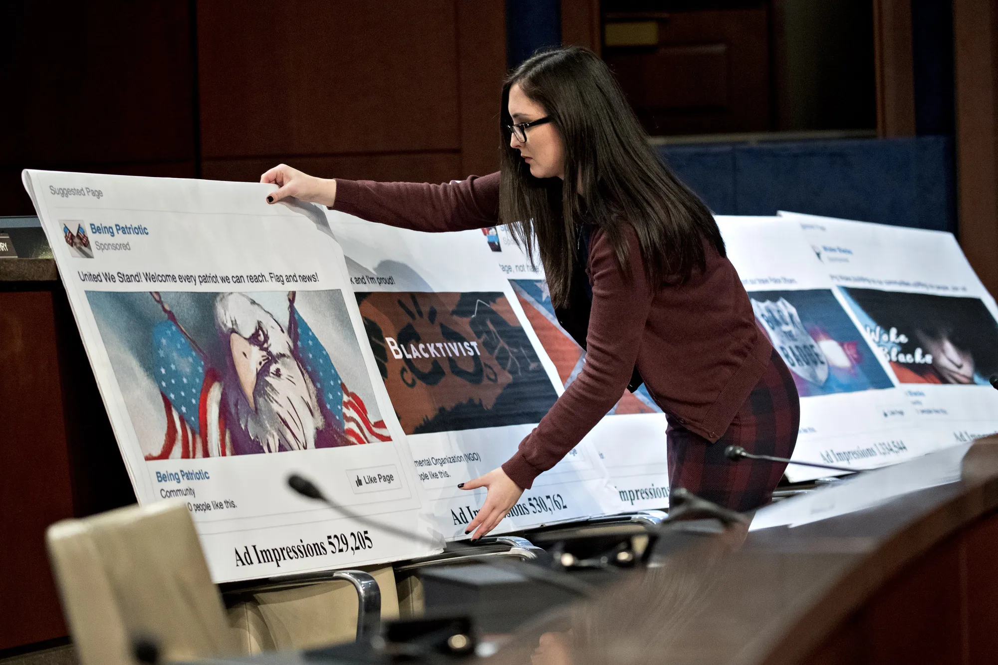 A staff member arranges a display showing a social media post during a House Intelligence Committee hearing in Washington, D.C., U.S., on Wednesday, Nov. 1, 2017.&nbsp;