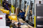Workers sort packages at a FedEx Express facility in New York.