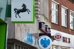 Signs outside branches of a Lloyds Banking Group Plc bank, a Barclays Bank Plc bank, a NatWest Group Plc bank and a HSBC Holdings Plc bank in Staines, U.K., on Friday, Feb. 12, 2021. The U.K. economy grew at double the pace expected in the fourth quarter, showing signs of resilience to coronavirus restrictions at the end of a year that delivered the worst recession since 1709.
