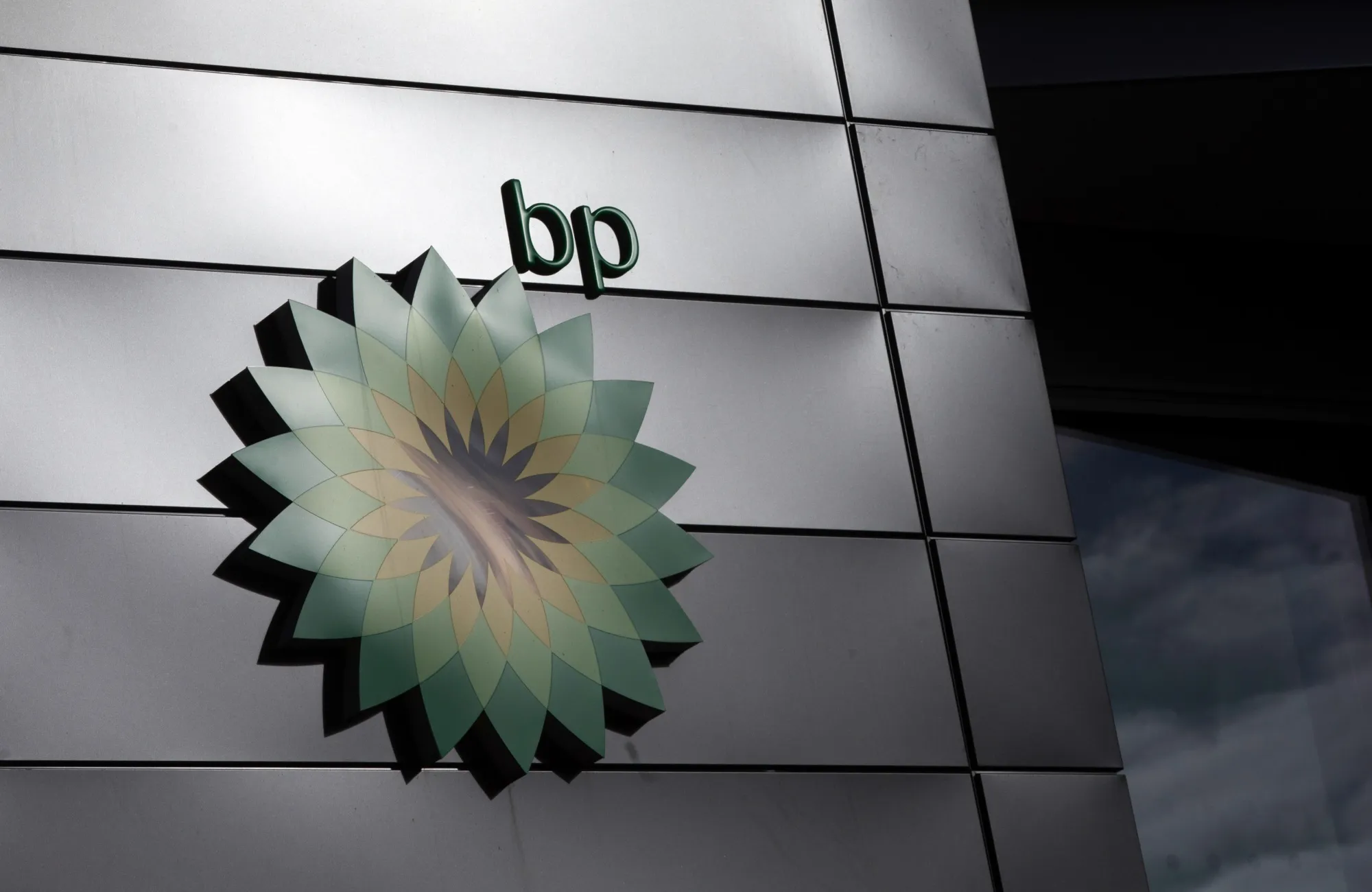 The BP Plc company logo at the entrance to the BP Pulse headquarters in Milton Keynes, U.K.