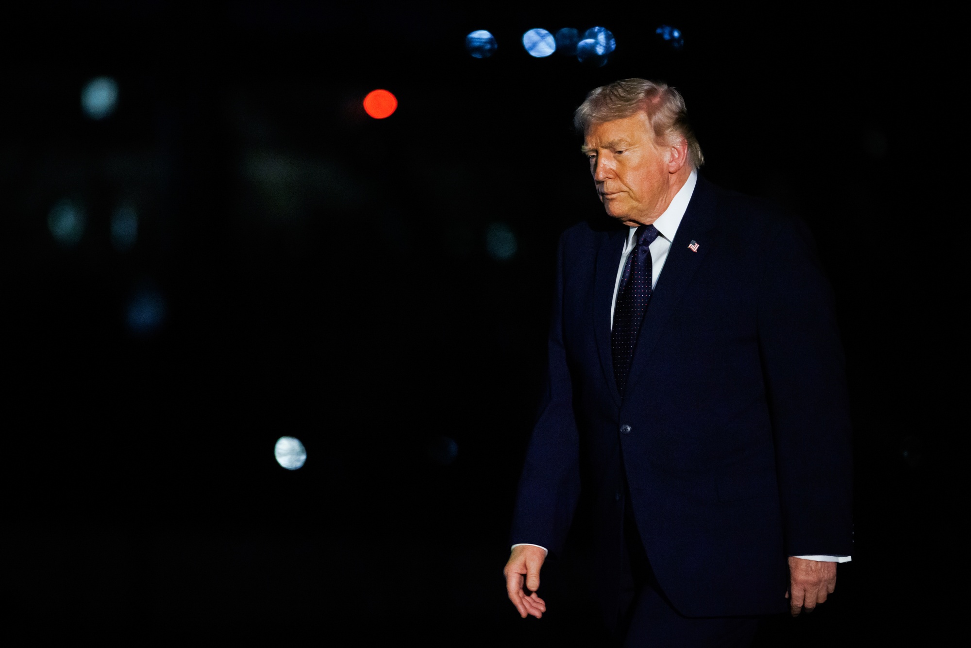US President Donald Trump walks on the South Lawn of the White House after arriving on Marine One in Washington, DC, US, on Monday, March 9, 2026. Trump said he would waive oil-related sanctions, have the US Navy escort tankers through the Strait of Hormuz and predicted on Monday that the war with Iran would resolve 