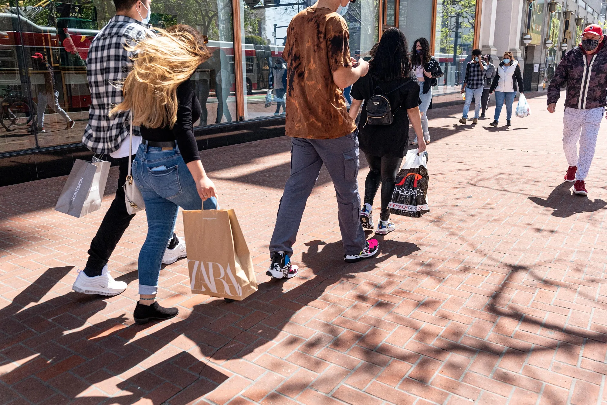 Shoppers carry bags on Market Street in San Francisco.