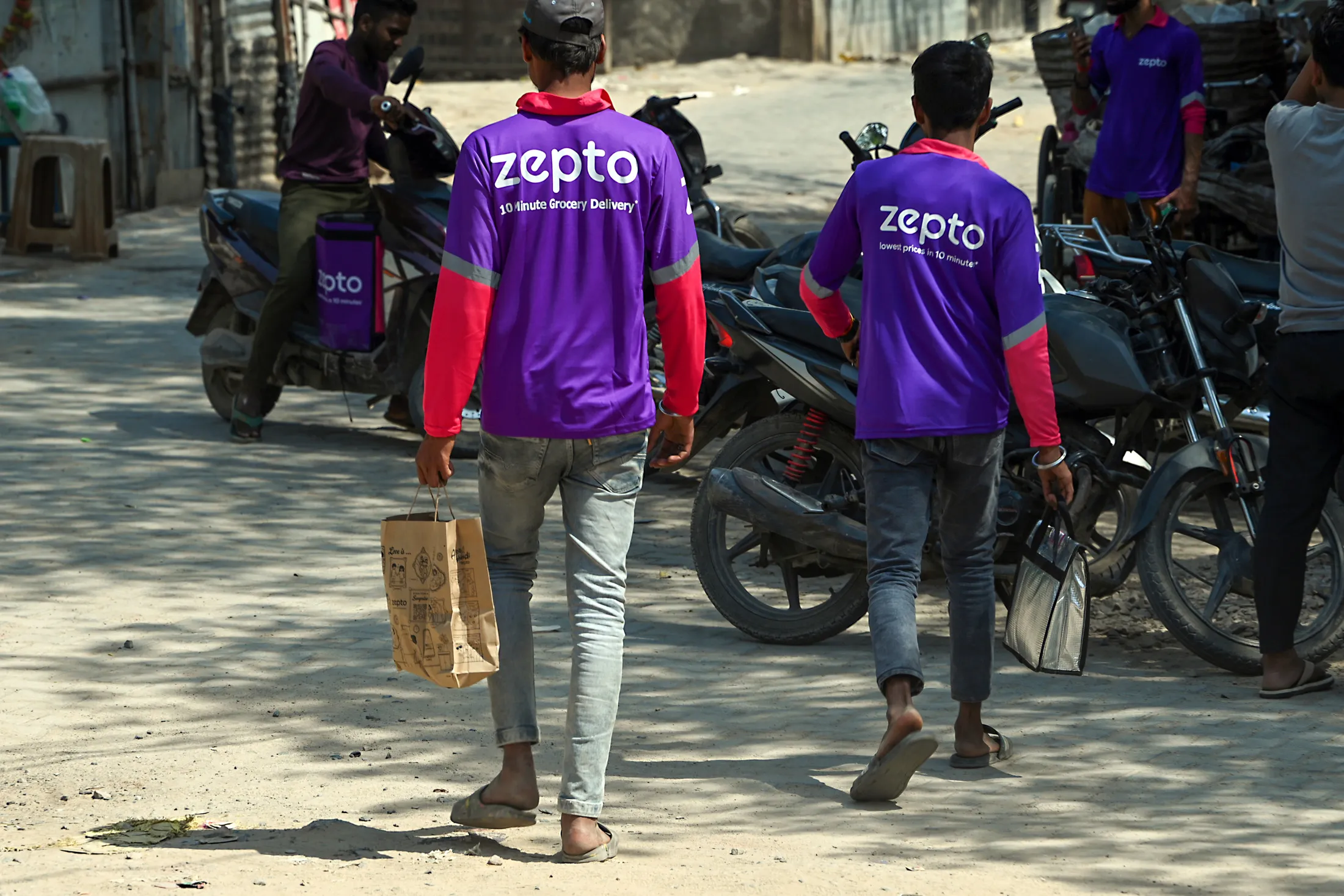 Zepto delivery workers outside a a Zepto dark store in Gurgaon, India.
