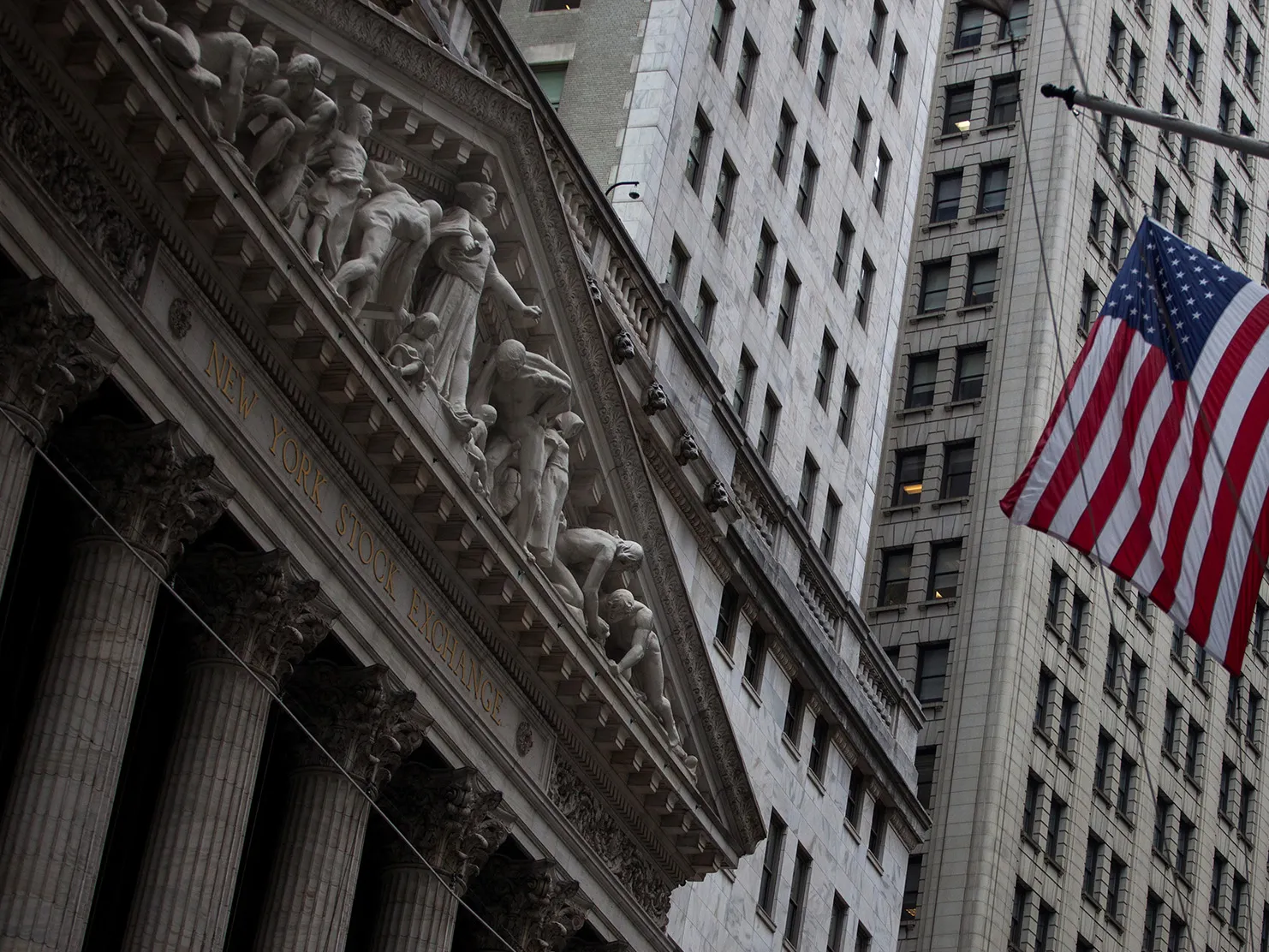 An American flag flies across from the New York Stock Exchange (NYSE) in New York, U.S., on Friday, May 4, 2018.
