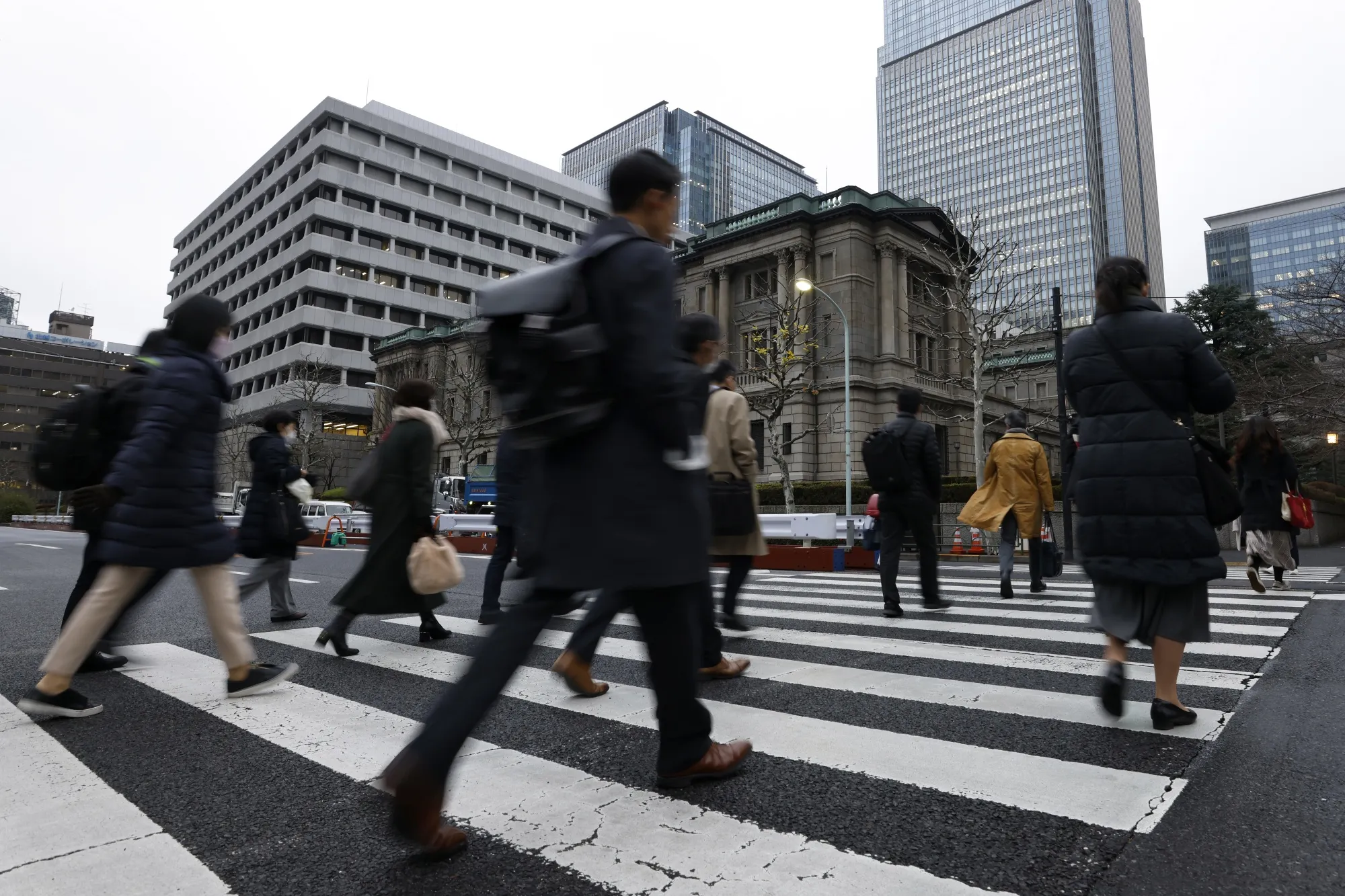 Pedestrians walk past the Bank of Japan&nbsp;headquarters in Tokyo, Japan.