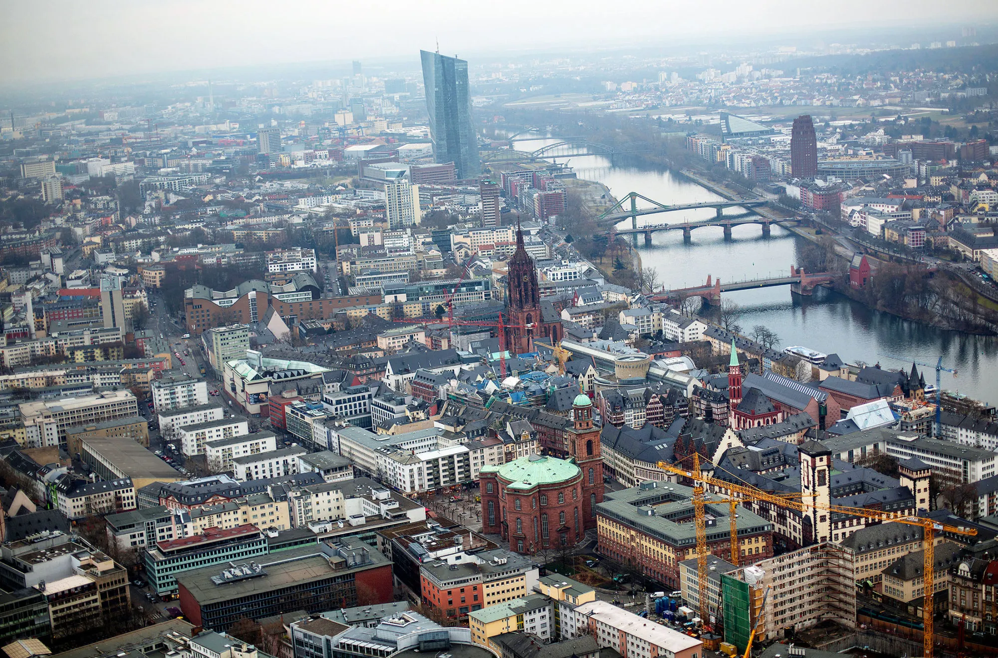 The skyscraper headquarter offices of the European Central Bank (ECB) stand beside the River Main as commercial and residential property sits on the city skyline in Frankfurt, Germany, on Thursday, Feb. 2, 2017. Frankfurt expects as many 10,000 workers from Britain's financial services industry to relocate to Germany's banking capital because of Brexit, with the exodus likely to start within weeks, according to lobby group Frankfurt Main Finance.
