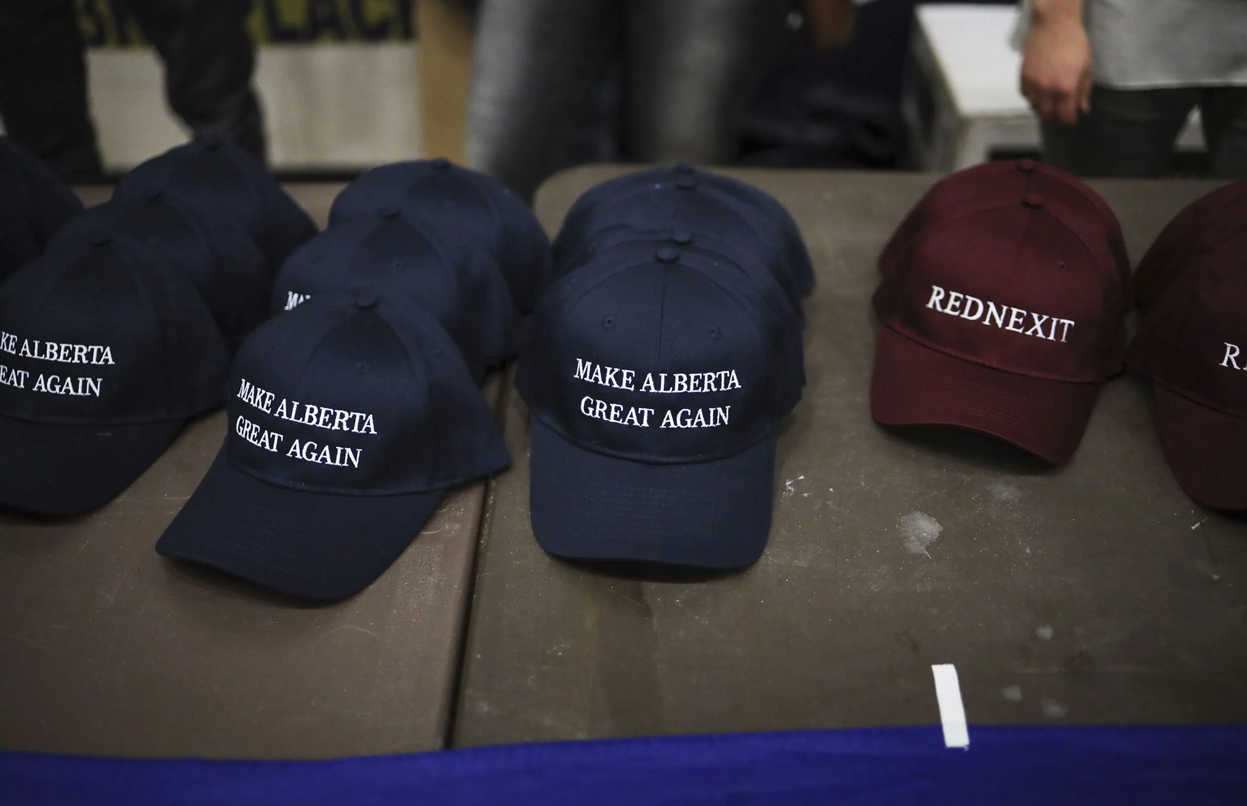 “Make Alberta Great Again” and “Rednexit” hats for sale during a Wexit rally at Notre Dame High School in Calgary on Nov. 16.