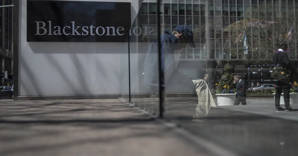 Pedestrians pass in front of Blackstone Group LP headquarters in New York, U.S., on Friday, April 14, 2017.