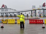 An officer gestures in front of one of the roads blocked by the police to restrict people leaving Wuhan in China's central Hubei province.