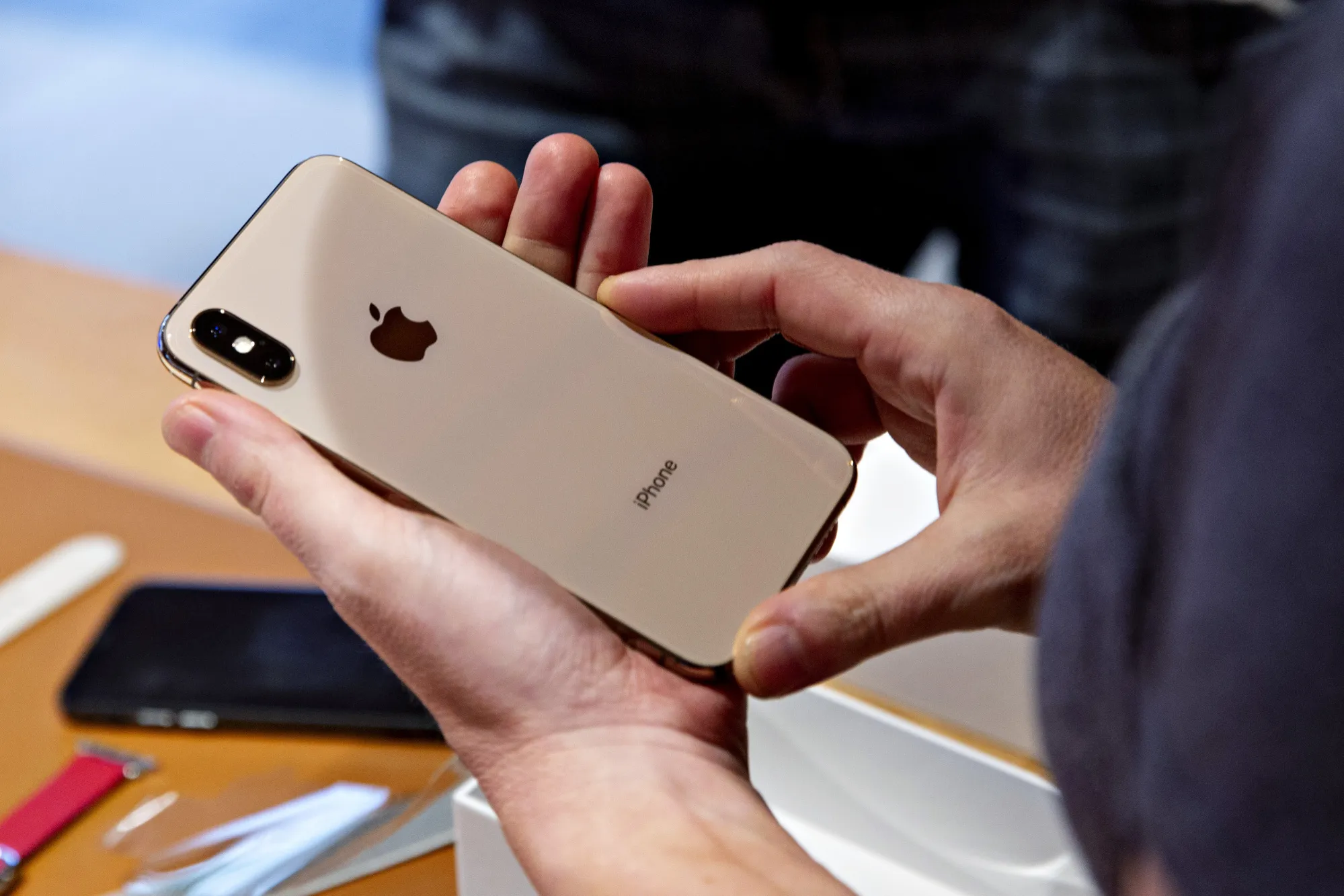 A customer views an Apple Inc. iPhone XS during a sales launch at a store in Chicago, Illinois.