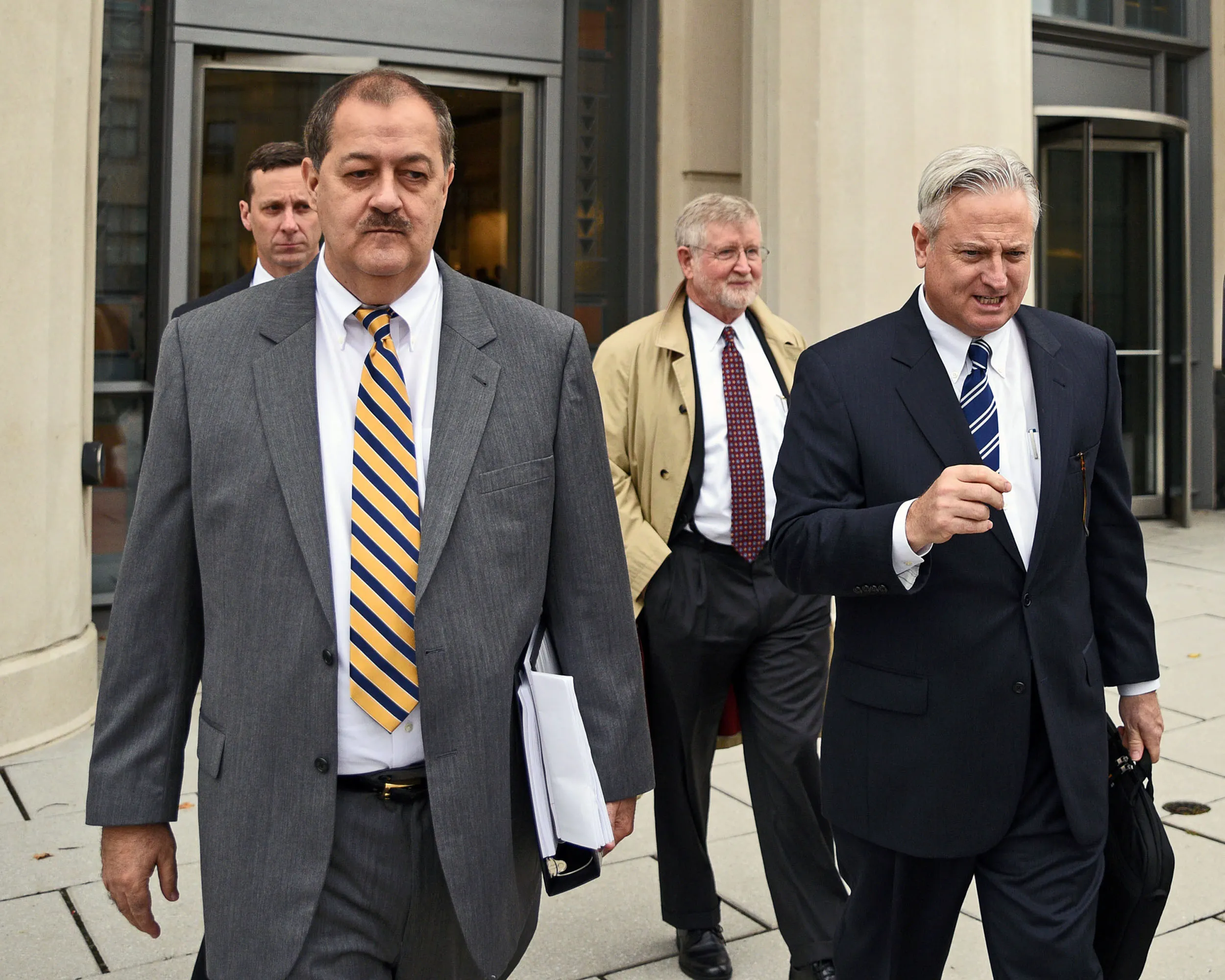 Donald Blankenship, left, makes his way out of the Robert C. Byrd United States Courthouse on the first day of jury selection in Charleston, on Oct. 1. Photographer: Tyler Evert/Ap Photo
