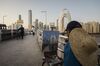 An artist works on a painting while sitting on the Liede Bridge over the Pearl River in Guangzhou, China, on Wednesday, Nov. 1, 2017. China is poised for an acceleration of deals as confidence grows in the wake of last month’s Communist Party gathering and as the nation opens up to reforms.