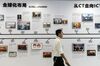 An employee walks past a display providing the history of Huawei Technologies Co. at Huawei University, the company's training facility, in Dongguan, China, on Thursday, May 23, 2019. Huawei is seeking about $1 billion from a small group of lenders, its first major funding test after getting hit with U.S. curbs that threaten to cut off access to critical suppliers.