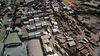 Shipping containers sit stacked at a freight depot near the Jawaharlal Nehru Port, operated by Jawaharlal Nehru Port Trust (JNPT), in this aerial photograph taken in Navi Mumbai, Maharashtra, India, on Saturday, May 25, 2019. President Donald Trump opened another potential front in his trade war on May 31, terminating India's designation as a developing nation and thereby eliminating an exception that allowed the country to export nearly 2,000 products to the U.S. duty-free.