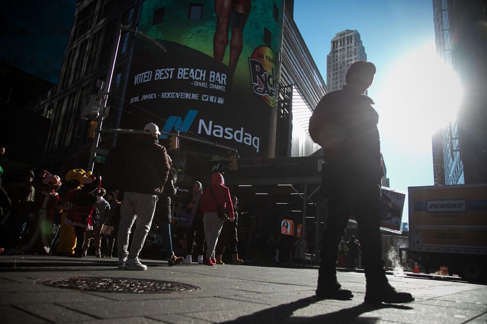 Pedestrians pass the Nasdaq MarketSite in New York, US.