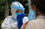 A health worker carrying out a Covid-19 coronavirus test in Dalian, in China's northeast Liaoning province.&nbsp;