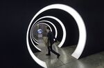 An attendee walks through the entrance of Tencent Holdings Ltd.'s WeChat Open Class Pro conference in Guangzhou, China.