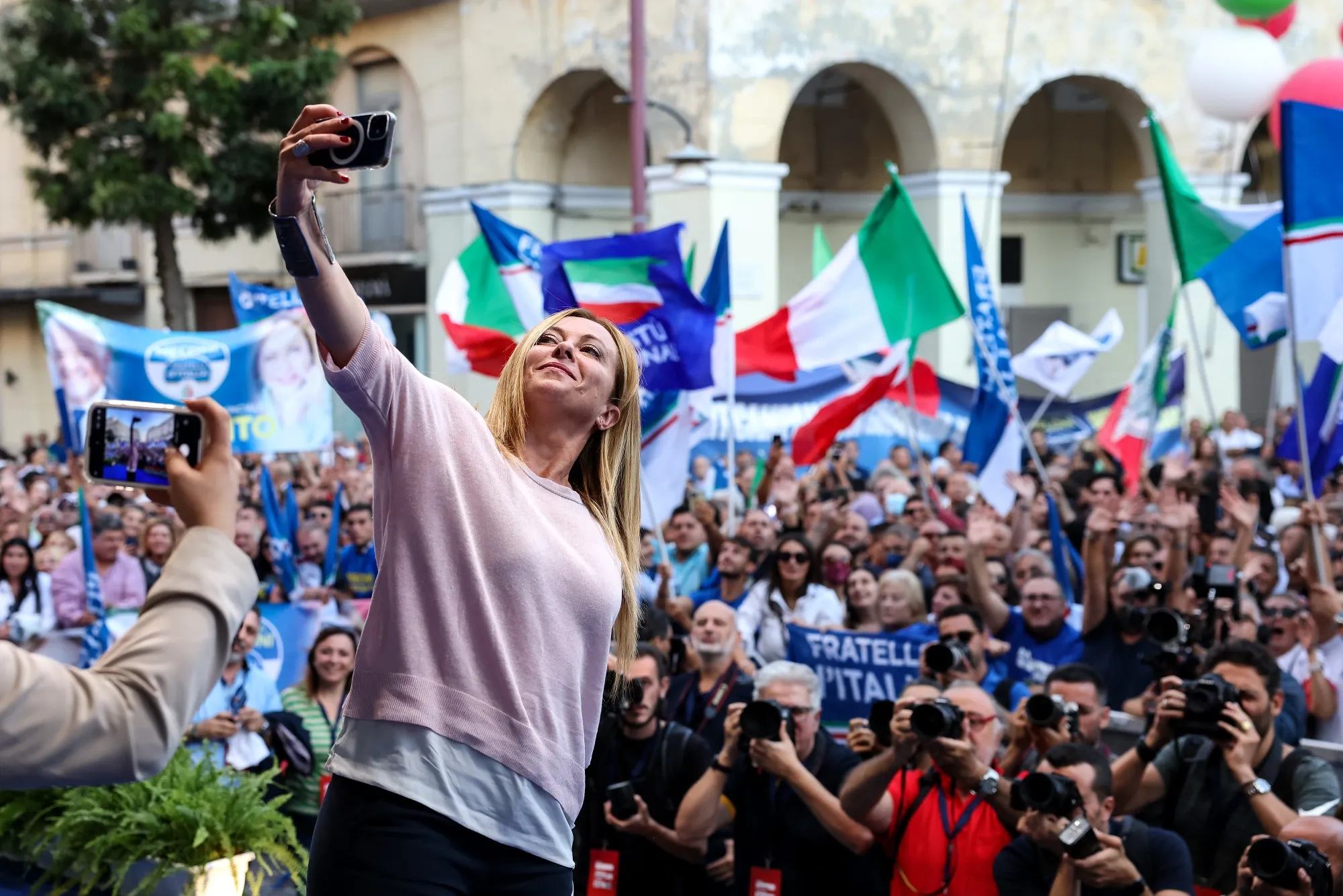 Meloni, leader of the Brothers of Italy Party, takes a selfie at the end of an election campaign rally in Caserta, last September.