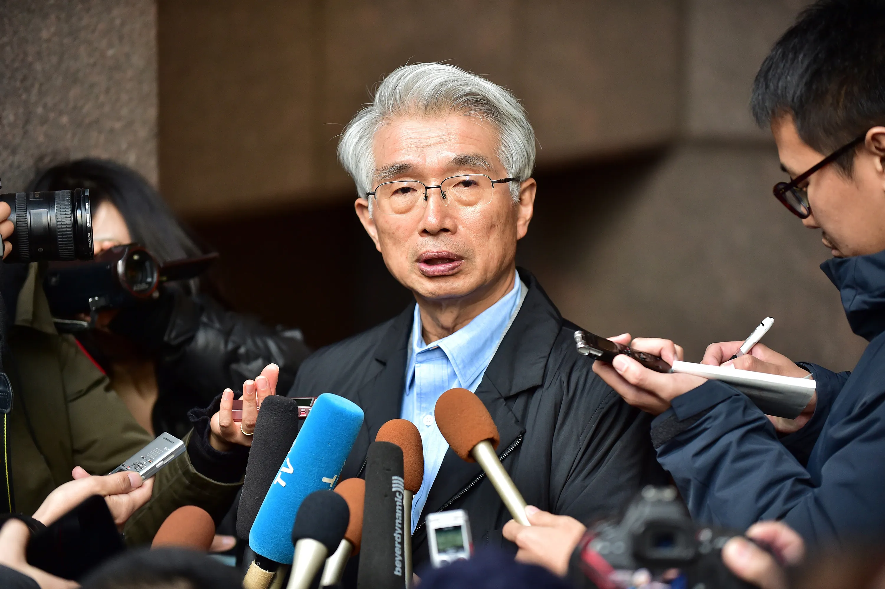 Junichiro Hironaka speaks to the media outside his office in Tokyo on Dec. 31, 2019.