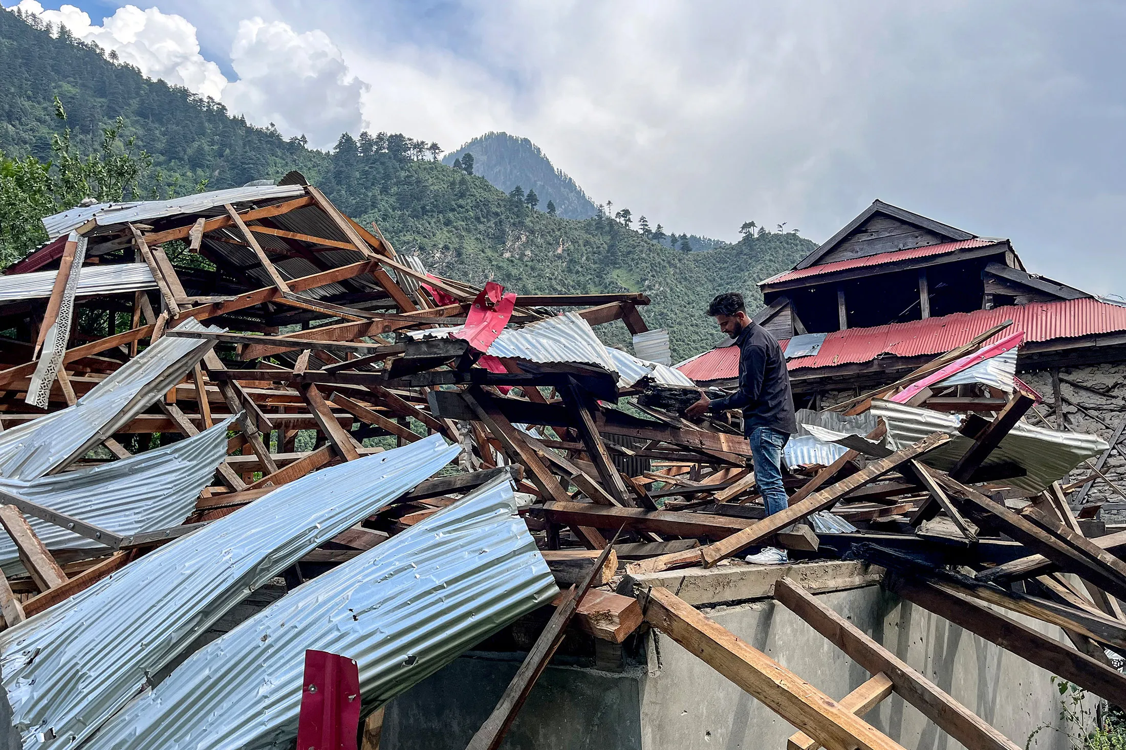 A resident inspects a damaged house after cross-border shelling along the Line of Control between Pakistan and India&nbsp;in the Neelum Valley of Pakistan-administered Kashmir, on May 11.