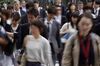 Morning commuters cross a road in Tokyo, Japan, on Tuesday, May 7, 2019.