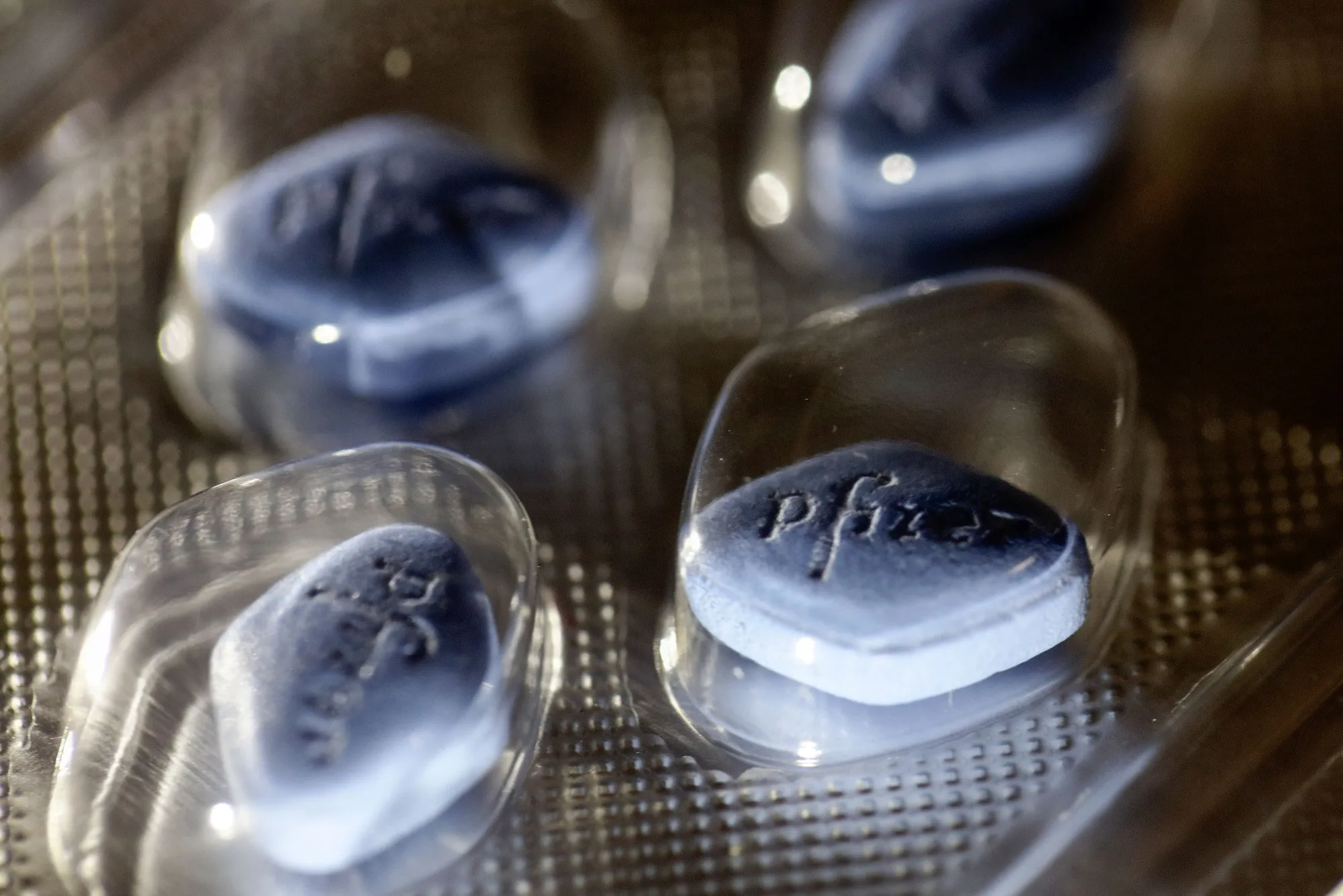 The Pfizer logo sits on Viagra tablets.