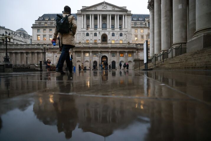 Commuters pass the Bank of England in the City of London.