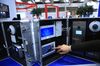 An exhibitor prepares a display of Alhua Technology video intercom products in the Zheijiang Dahua Technology Co. Ltd. pavilion at the CeBIT 2017 tech fair in Hannover, Germany, on Tuesday, March 21, 2017. Leading edge technologies in the digital world are showcased in this annual event which runs March 20 - 24.