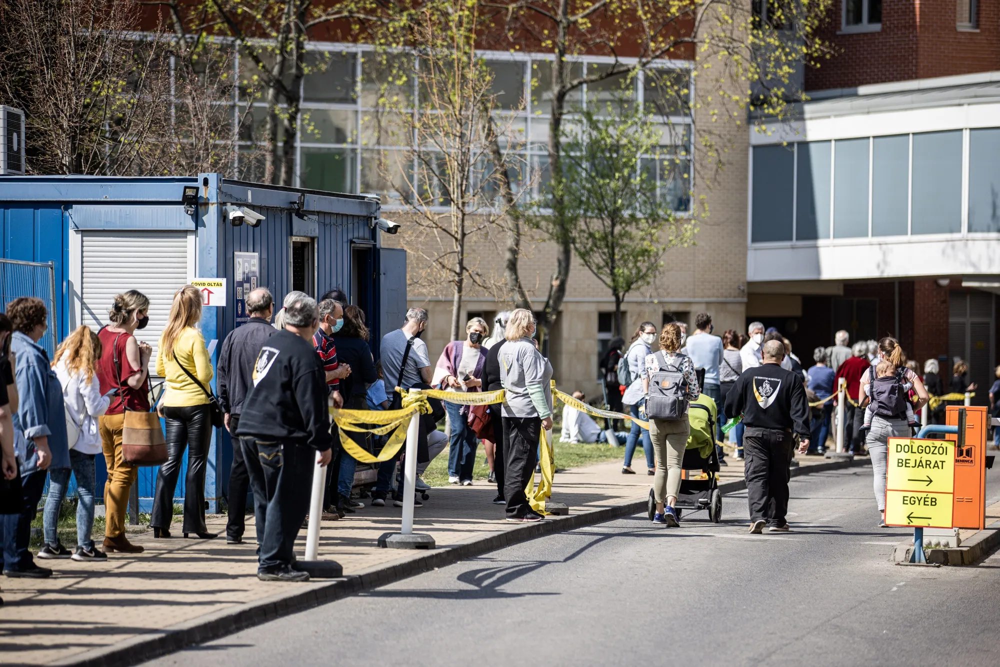 Patients wait in line outside a vaccination point at Semmelweis University Hospital in Budapest on April 1.